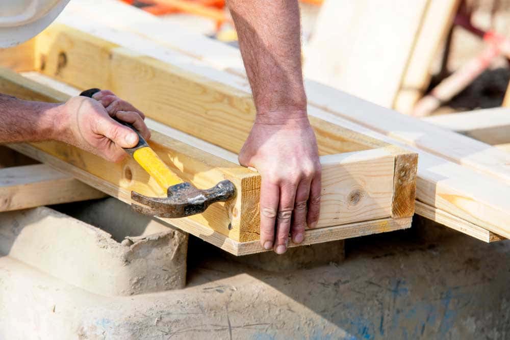 Carpenter marking out a timber section on site