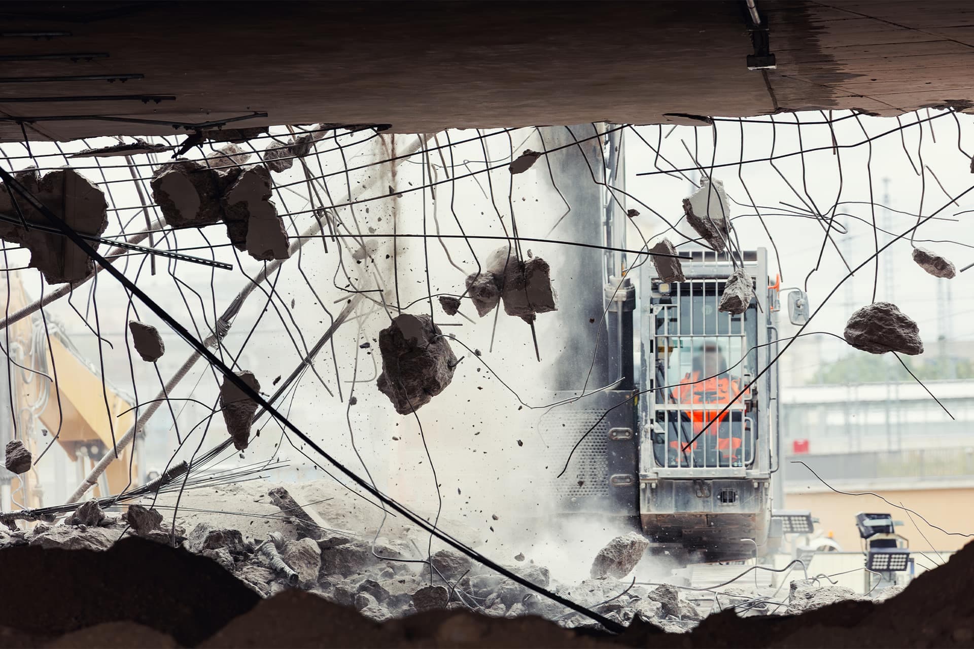 Concrete and reinforcement breaking out during controlled demolition